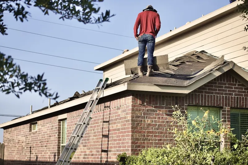 Professional roofer working on a residential roof in Bloomingdale